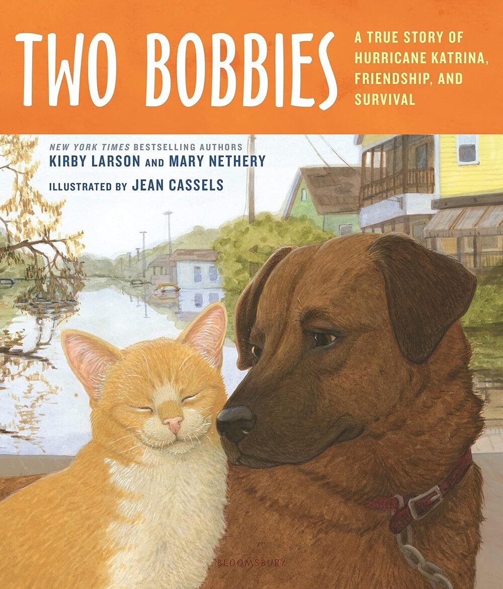 Cover of Two Bobbies. An orange cat rests its head against a brown dog on a New Orleans street.